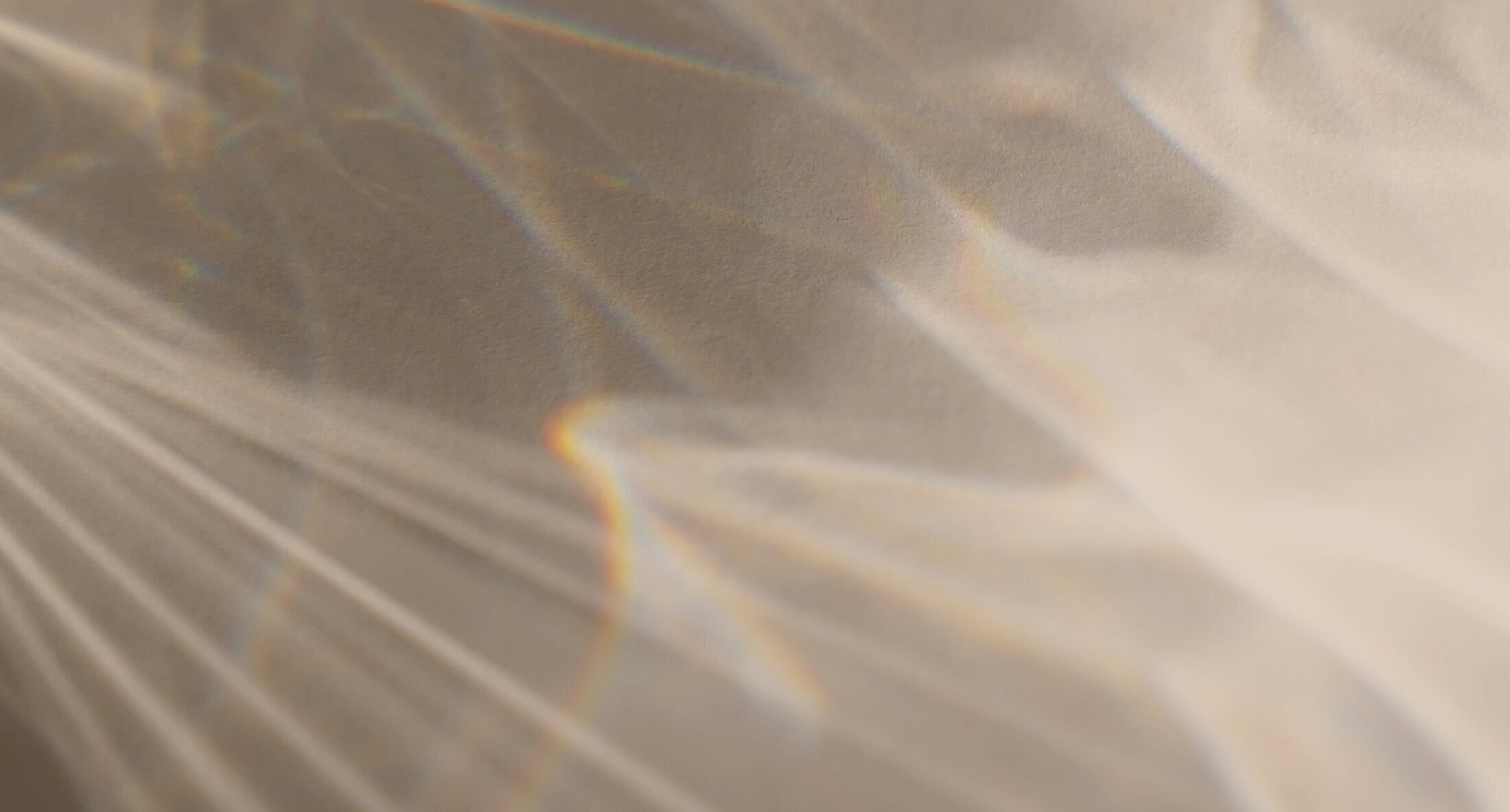 Abstract light reflections on textured surface.